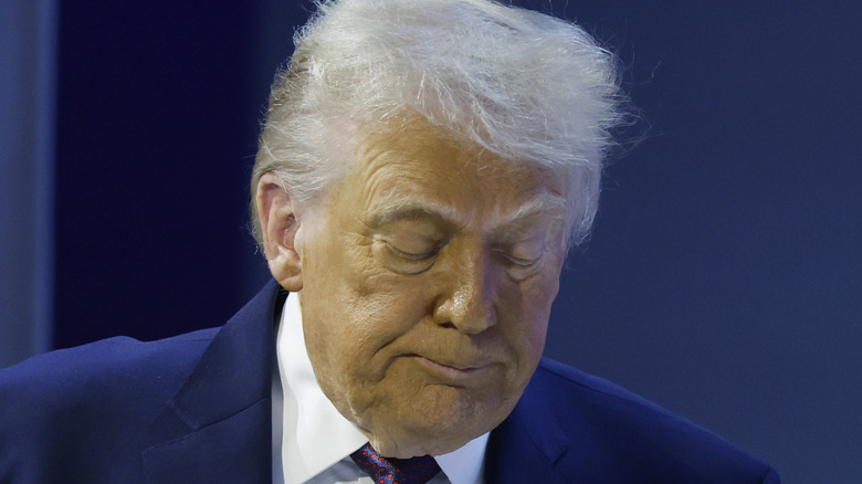 image of Donald Trump looking down with a yellow-ish face