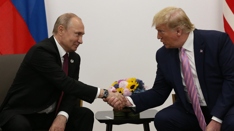 Donald Trump awkwardly shakes hands with Vladimir Putin