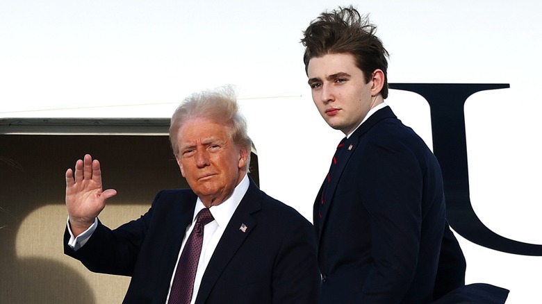 Donald Trump and Barron Trump looking into a camera outside a plane, while Donald waves