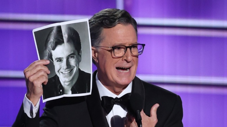 Stephen Colbert holds up his headshot onstage during the 77th Primetime Emmy Awards in Los Angeles, CA (2025)