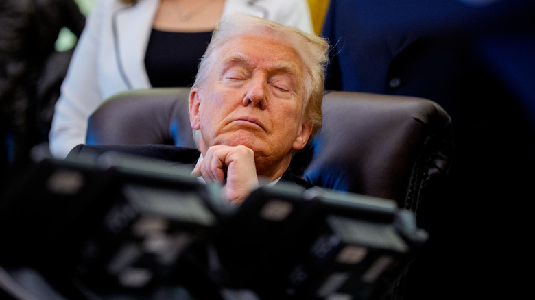 Donald Trump seemingly asleep behind the Resolute desk