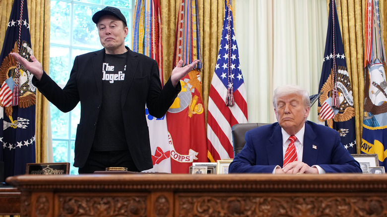 Elon Musk shrugging his shoulders as Donald Trump sits at his desk in the Oval Office