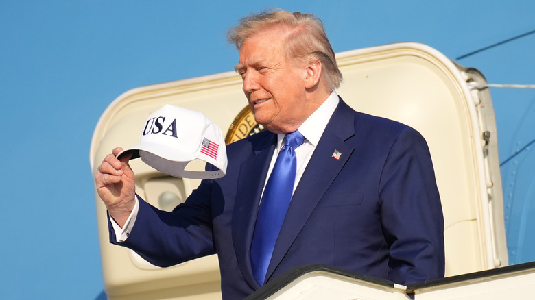 Donald Trump holding a hat