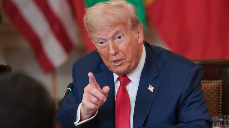 Donald Trump seated pointing