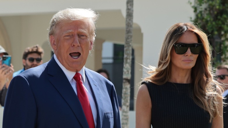 Donald Trump talking, Melania Trump in sunglasses