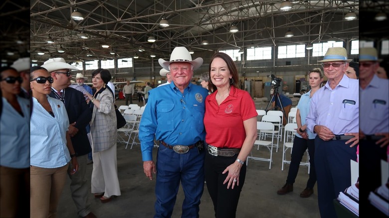 Brooke Rollins posing with a man in a cowboy hat.