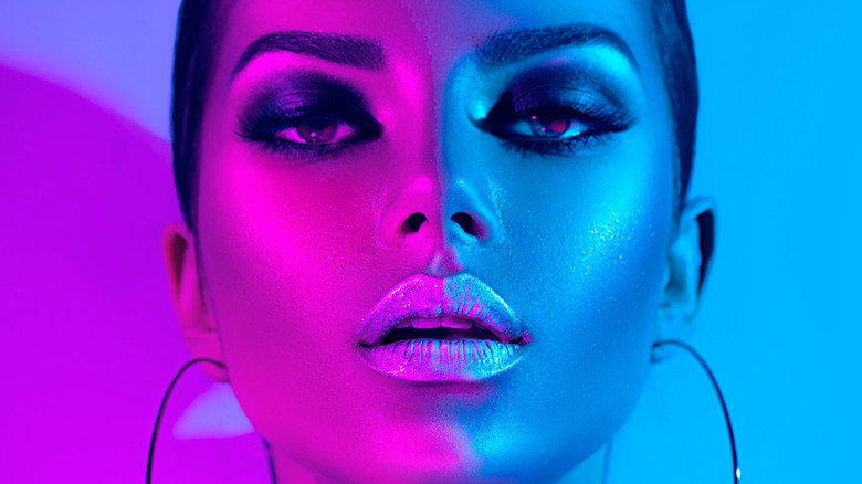 Woman wearing a makeup look with a lot of highlighter