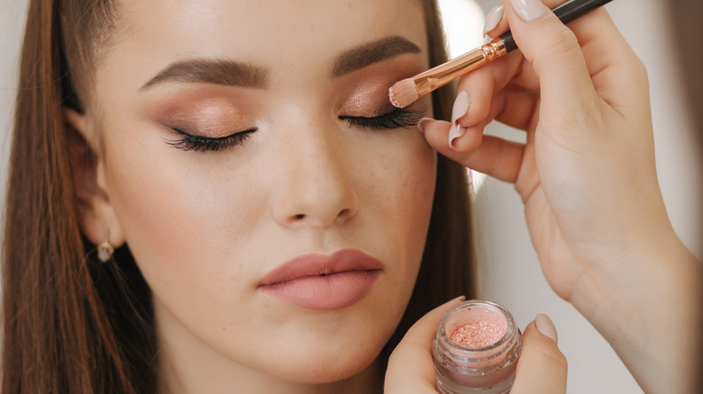 Woman getting her makeup done