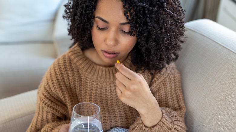 woman about to take pill