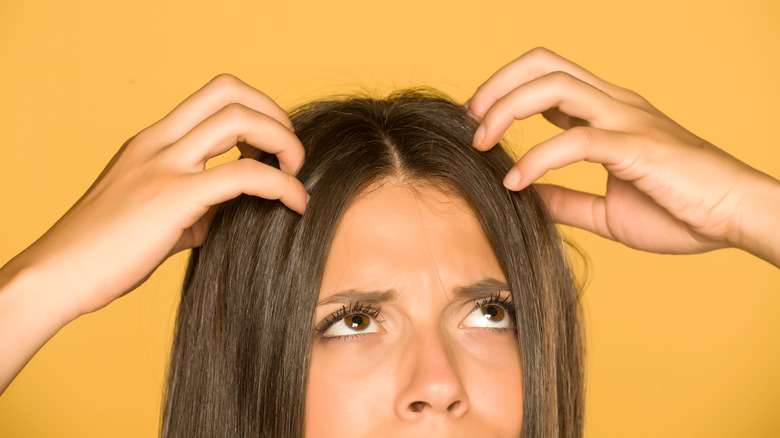 Woman analysing greasy hair roots