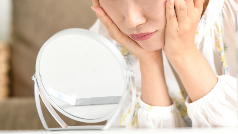 A woman looking in a mirror