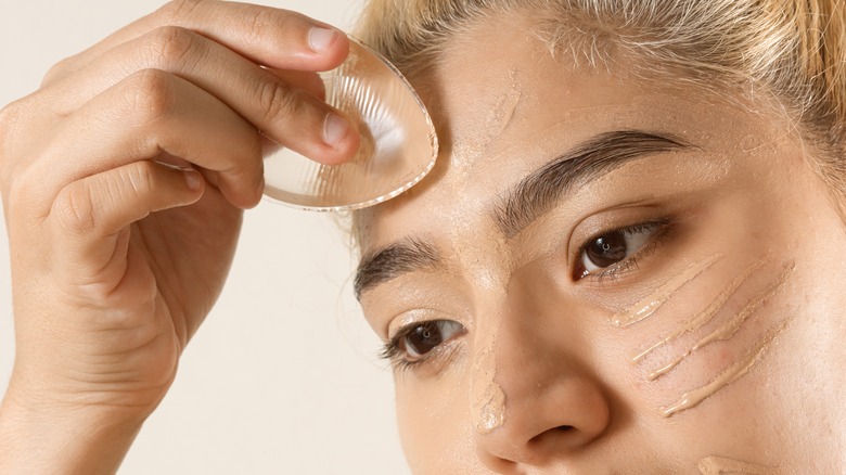 A woman applying foundation