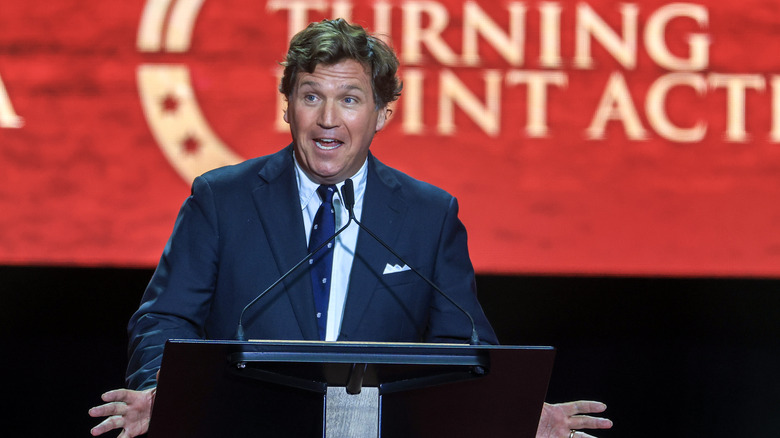 Tucker Carlson speaking at a Turning Point USA event