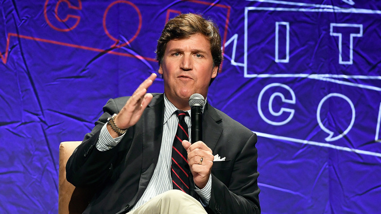 Tucker Carlson speaking to an audience