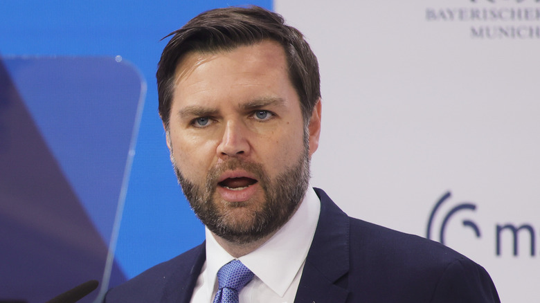 JD Vance shocked face in a suit with a blue tie