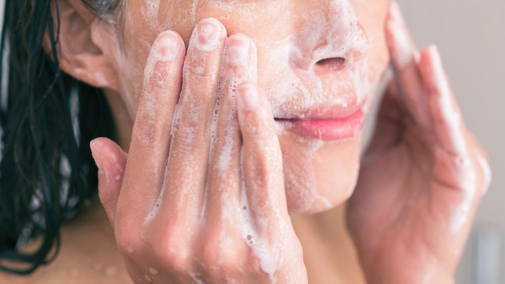 woman washing her face