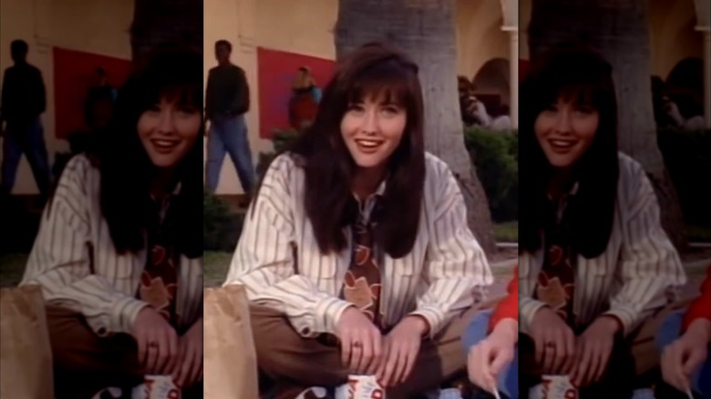 Shannen Doherty as Brenda Walsh in oversized buttondown shirt and tie