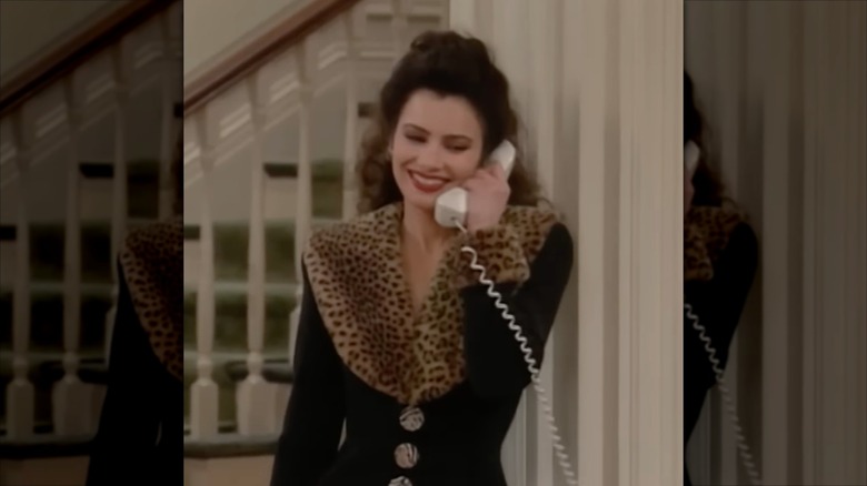 Fran Drescher in character as The Nanny wearing an animal print-trimmed coat