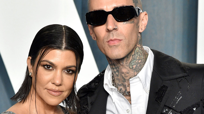 Kourtney and Travis smiling on red carpet