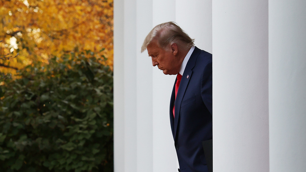 Trump walking to a press conference