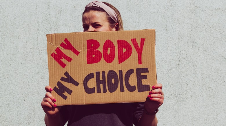 woman holding my body my choice protest sign 