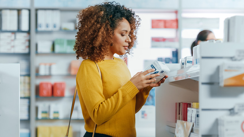 Woman shopping for medications in a pharmacy