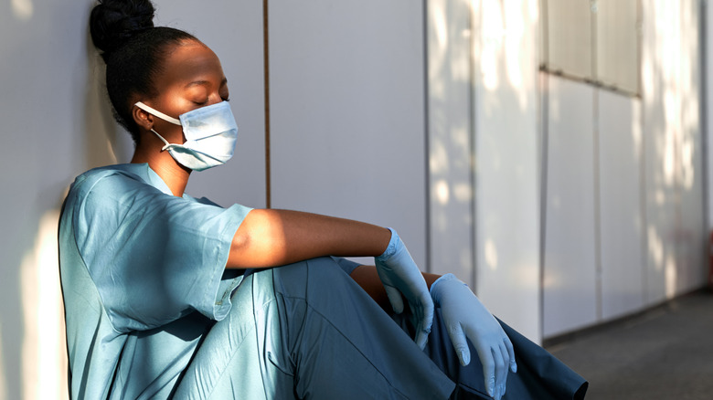 nurse in scrubs and mask 