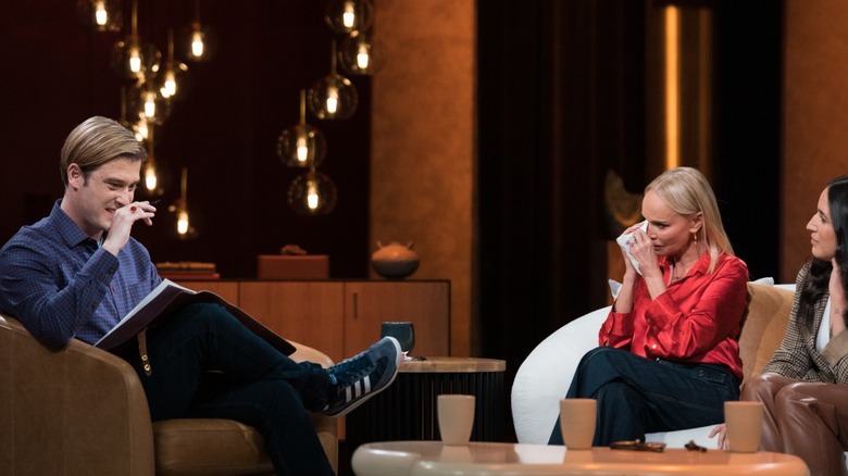 Tyler Henry on stage during a "Live from the Other Side" session with a crying Kristin Chenoweth