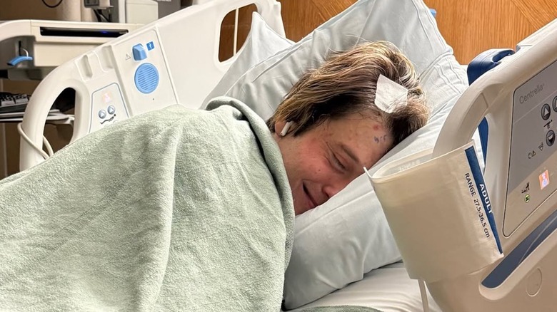 Tyler Henry recovers in a hospital bed after surgery