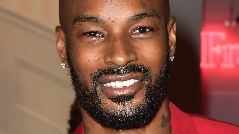 Tyson Beckford smiles with a beard.