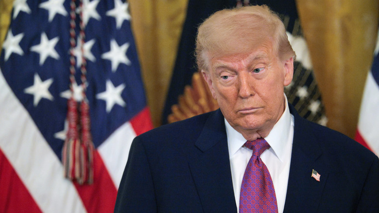 Donald Trump looking down as he stares at the floor