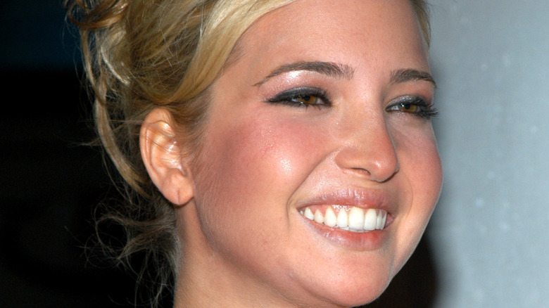 Ivanka Trump smiling at a movie premiere with bright red cheeks