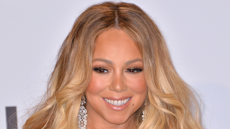 Mariah Carey smiling on the red carpet of an event