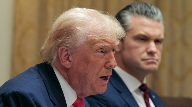 President Donald Trump speaks as U.S. Secretary of War Pete Hegseth (R) looks on during a meeting of his Cabinet in the Cabinet Room of the White House on December 02, 2025 in Washington, DC.