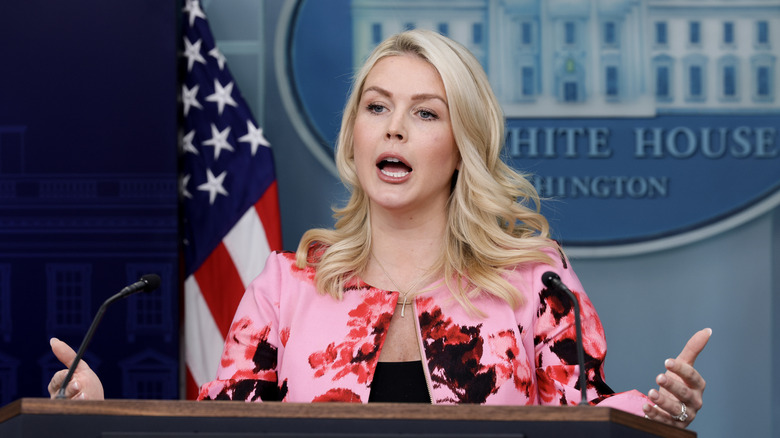 Karoline Leavitt yelling and gesturing at the White House podium