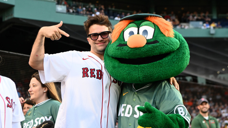 Tom Schwartz (from "Vanderpump Rules" and "The Valley") posing with Wally the mascot in 2025
