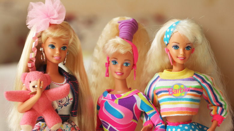 Three Barbies in 1980s outfits