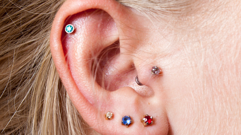 person with unique and unusual ear piercing placements and jewelry