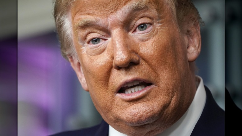Donald Trump has white patches of skin around his eyes and eyebrows in a close-up photo.