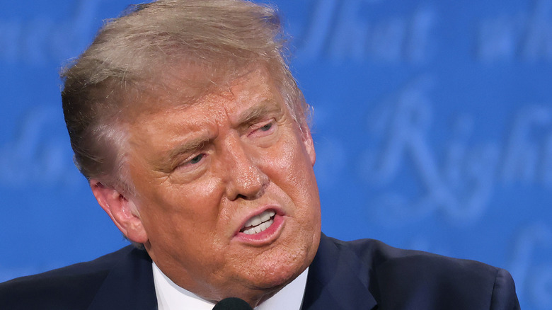 Donald Trump sweats and scowls while looking off to the side during his first 2020 presidential debate with Joe Biden.