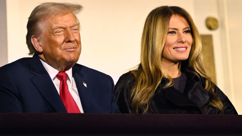 Donald and Melania Trump seated smiling right angle
