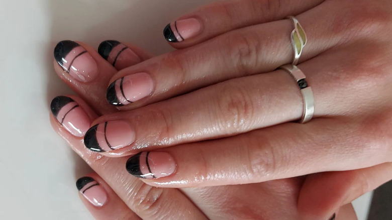 Black tipped nails with a decorative line