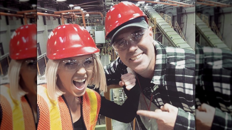 Dave and Kortney Wilson smiling together and wearing hard hats in 2016