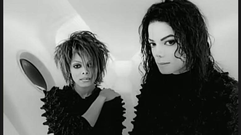 Janet Jackson standing next to Michael Jackson while wearing heavy makeup and making an intense face.