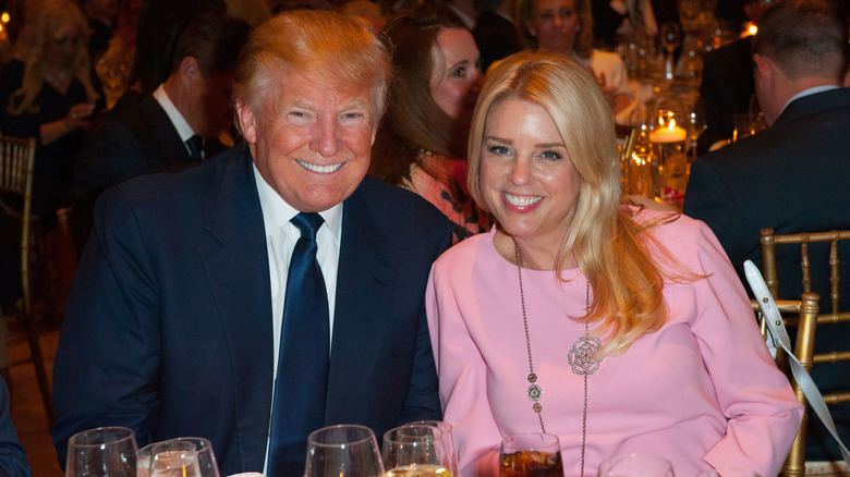 Donald Trump and Pam Bondi smiling at dinner in 2016