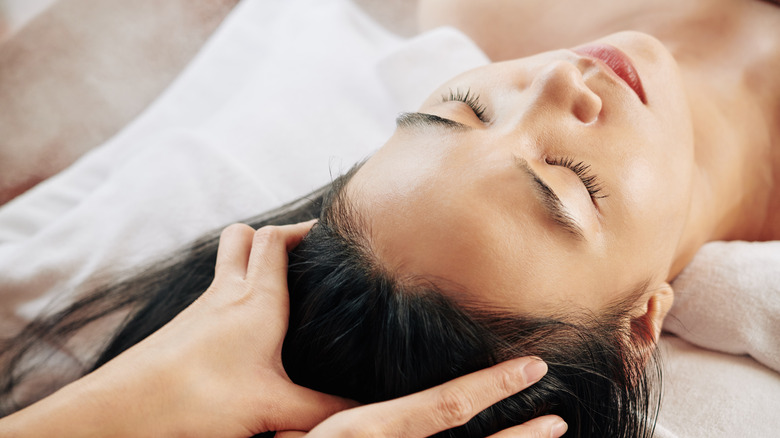 Woman receiving scalp massage