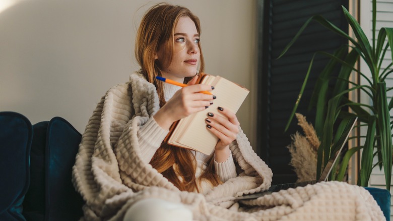 A woman holding a notebook. 