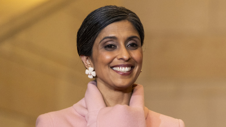 Usha Vance smiling with hair pulled back and floral earrings
