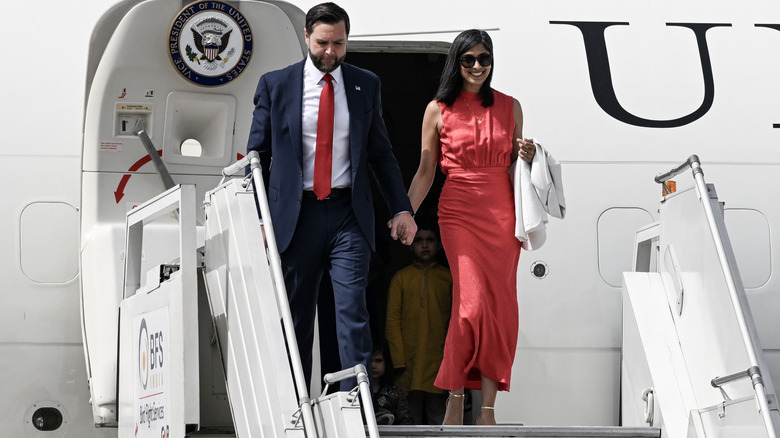 Usha Vance wearing a red outfit while deplaning with JD Vance in India