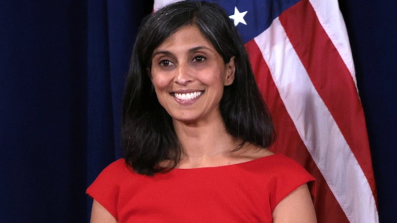 Usha Vance in front of American flag, smiling, her red dress visible from chest up